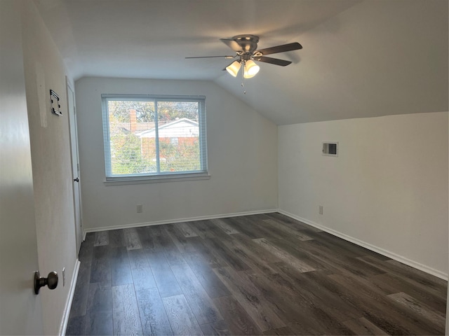 additional living space featuring ceiling fan, dark hardwood / wood-style flooring, and vaulted ceiling