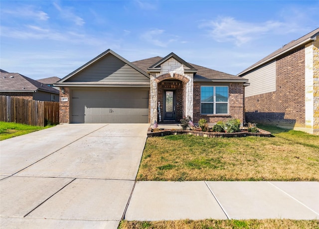 view of front of property featuring a garage and a front lawn