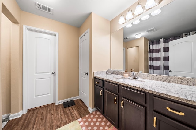 bathroom with vanity and wood-type flooring