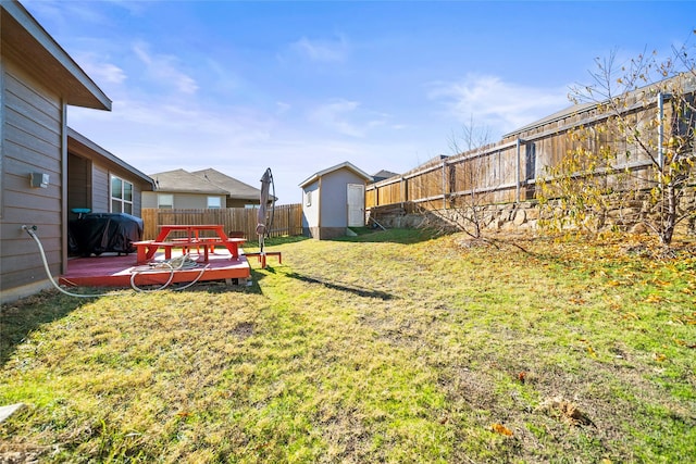 view of yard with a deck and a shed