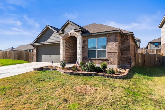 view of front of home featuring a garage and a front lawn