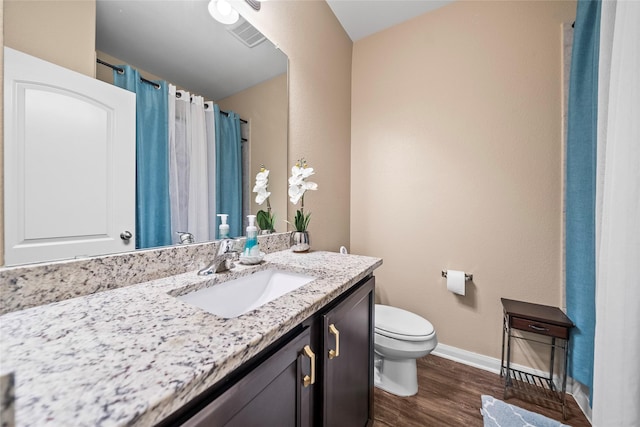 bathroom featuring vanity, toilet, and wood-type flooring