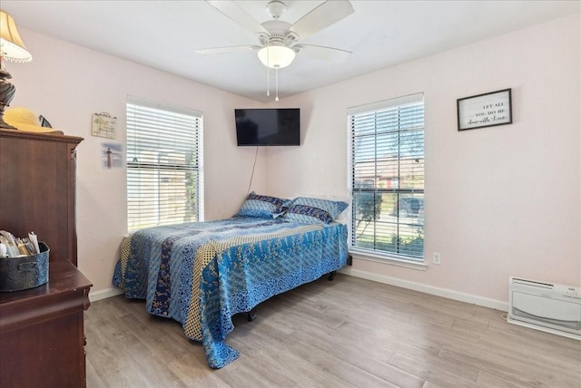 bedroom featuring ceiling fan and light hardwood / wood-style floors