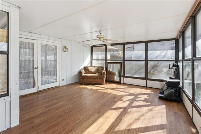 unfurnished sunroom with ceiling fan