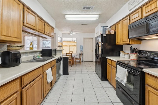 kitchen featuring black appliances, sink, ceiling fan, a textured ceiling, and light tile patterned flooring