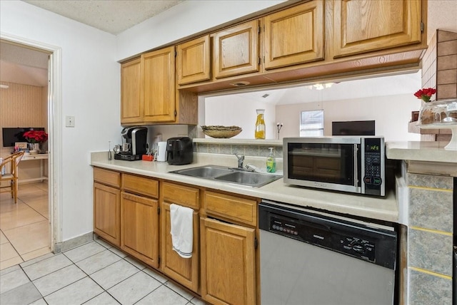 kitchen with sink, light tile patterned floors, and stainless steel appliances