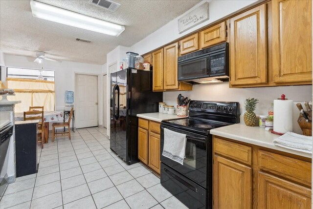 kitchen featuring light tile patterned flooring, a textured ceiling, ceiling fan, and black appliances