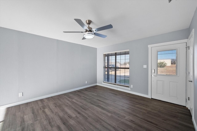 foyer with a healthy amount of sunlight, ceiling fan, and dark wood-type flooring