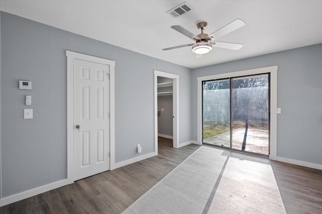 empty room with ceiling fan and hardwood / wood-style flooring