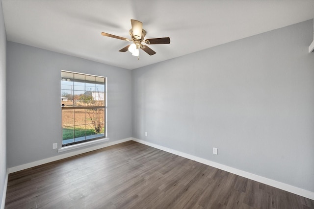 empty room featuring dark hardwood / wood-style flooring and ceiling fan