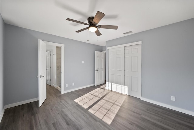 unfurnished bedroom featuring ceiling fan, a closet, and dark hardwood / wood-style floors