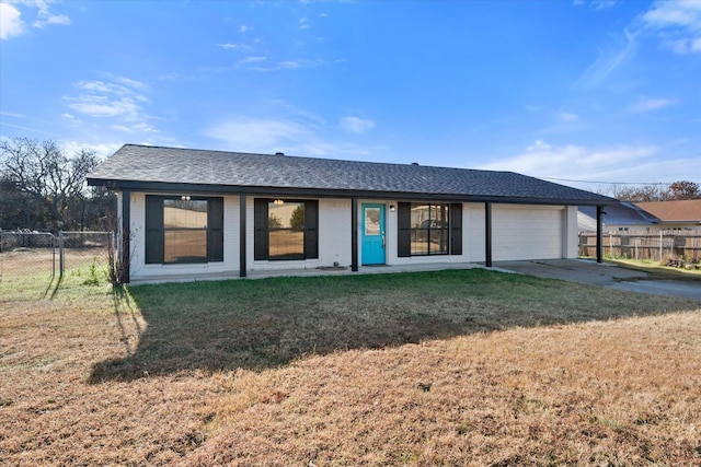 rear view of property featuring a garage and a yard