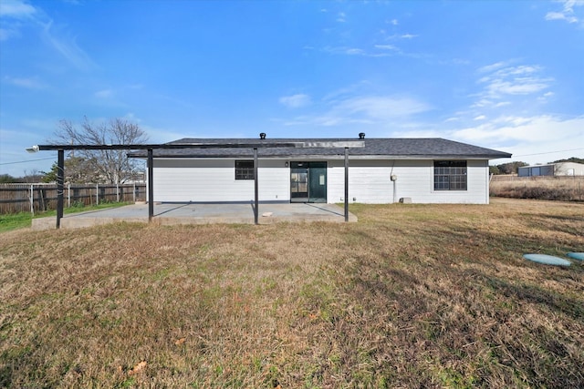 rear view of property featuring a yard and a patio