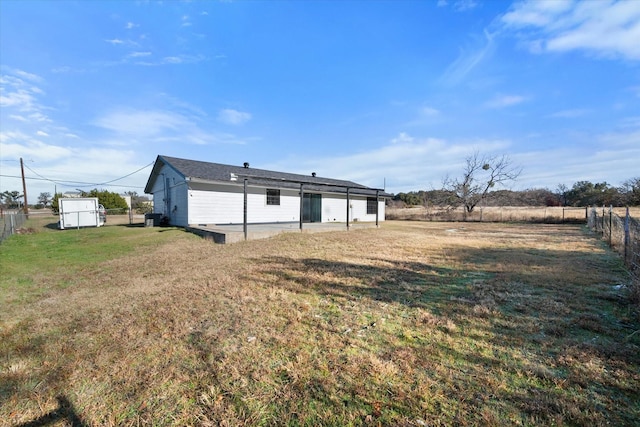 rear view of house featuring a yard