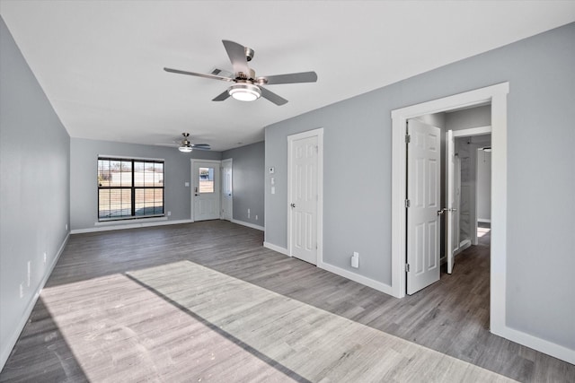 empty room with ceiling fan and light hardwood / wood-style flooring