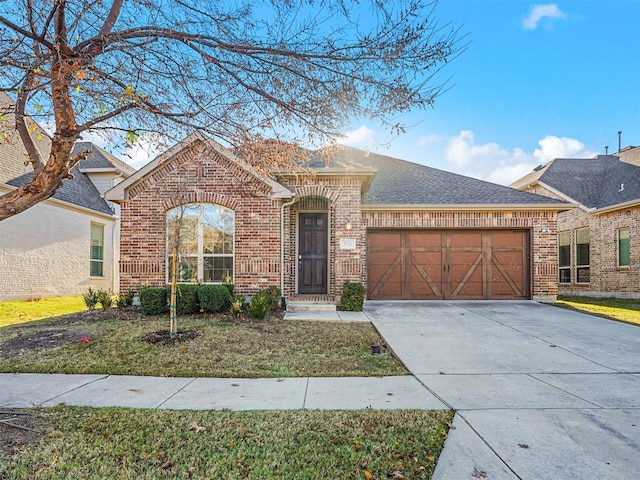 view of front of property with a garage and a front lawn