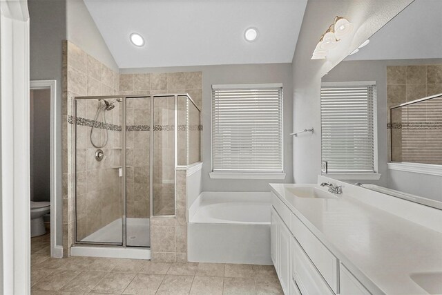 full bathroom featuring tile patterned floors, separate shower and tub, vanity, and lofted ceiling