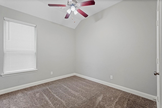 carpeted spare room with ceiling fan and vaulted ceiling