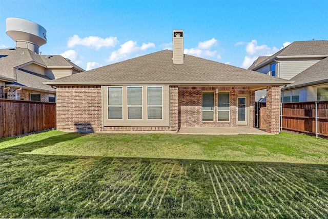 back of property featuring a patio area and a lawn