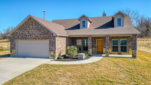 view of front of home featuring a porch, a garage, and a front lawn