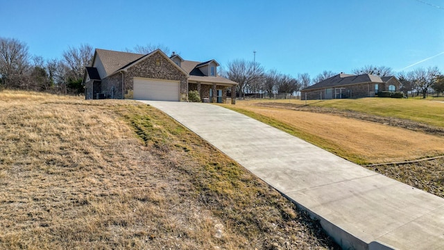 view of front of house featuring a garage and a front lawn