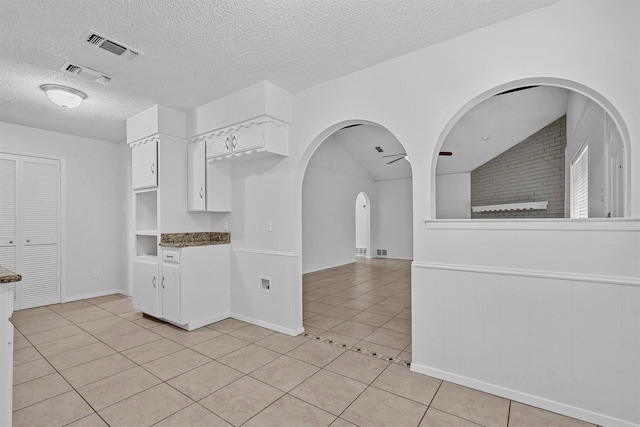 interior space featuring vaulted ceiling and a textured ceiling