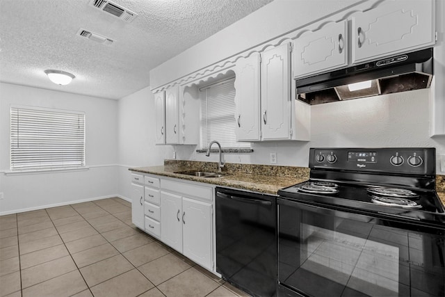 kitchen with dark stone counters, sink, black appliances, light tile patterned floors, and white cabinets