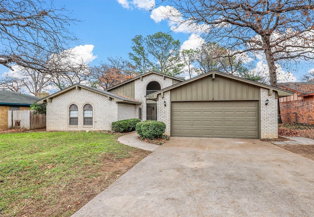 view of front of property featuring a front yard and a garage