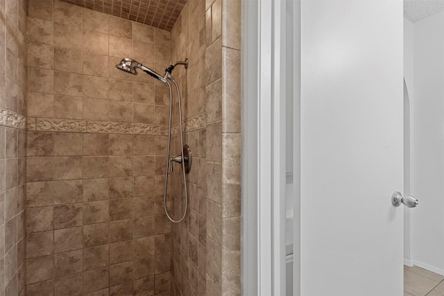 bathroom with a tile shower