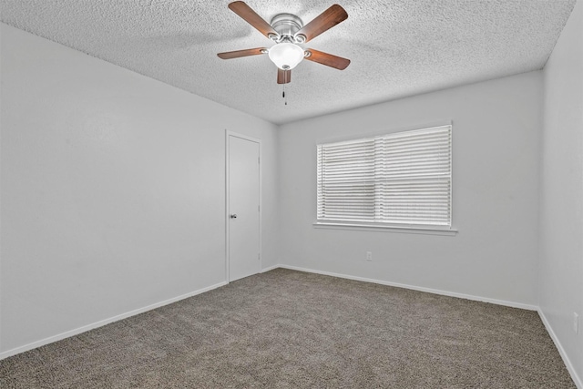 carpeted spare room featuring a textured ceiling and ceiling fan