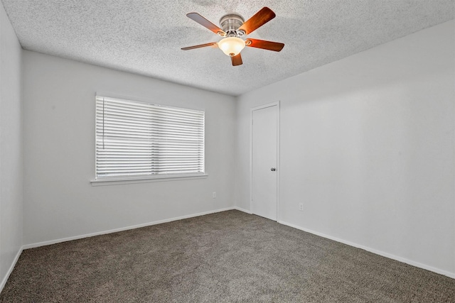 carpeted empty room featuring ceiling fan and a textured ceiling