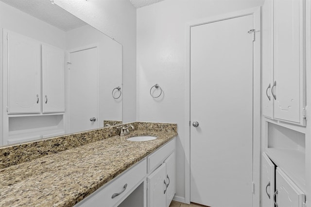 bathroom with vanity and a textured ceiling