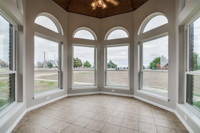 unfurnished sunroom featuring ceiling fan, wood ceiling, and vaulted ceiling