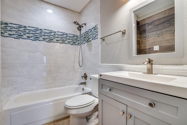 full bathroom with vanity, tiled shower / bath combo, and toilet