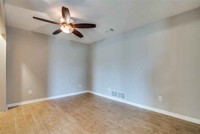 empty room with ceiling fan and light hardwood / wood-style flooring