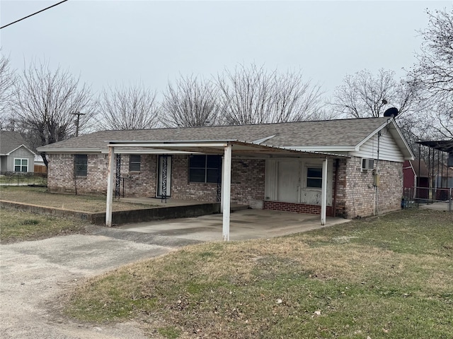 view of side of property featuring a yard and a carport