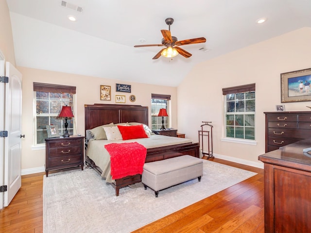 bedroom featuring light wood-type flooring, vaulted ceiling, and ceiling fan