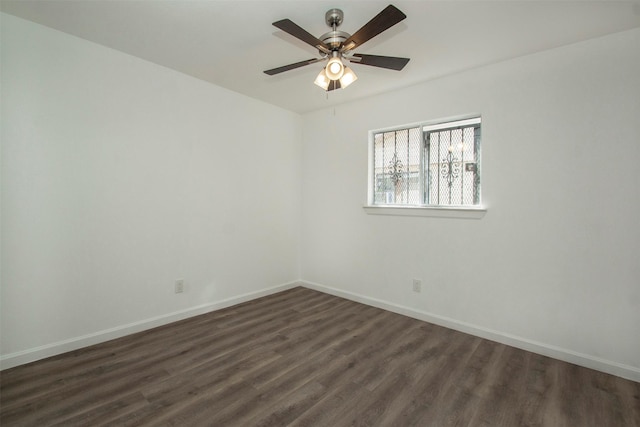 empty room featuring dark hardwood / wood-style flooring and ceiling fan