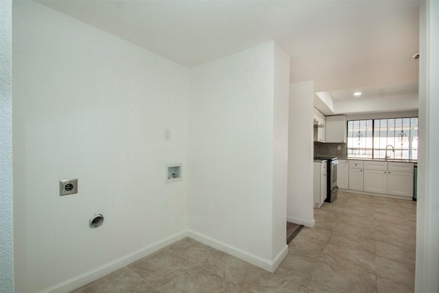 clothes washing area with washer hookup, electric dryer hookup, light tile patterned floors, and sink