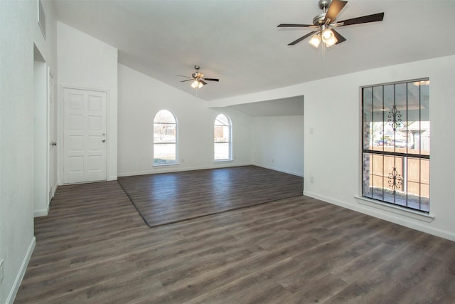 interior space featuring ceiling fan, dark wood-type flooring, and vaulted ceiling