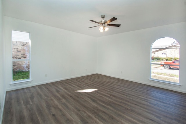 empty room featuring dark hardwood / wood-style floors and ceiling fan