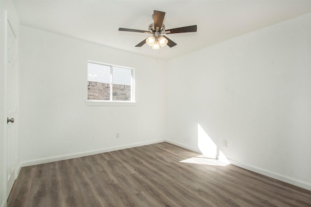 empty room featuring dark hardwood / wood-style floors and ceiling fan