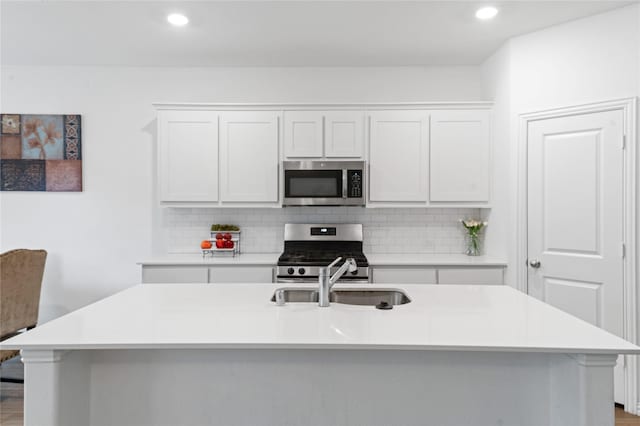 kitchen with white cabinetry, sink, an island with sink, and stainless steel appliances