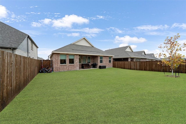 rear view of property featuring a lawn