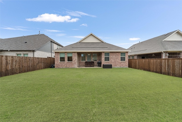 rear view of property featuring a lawn