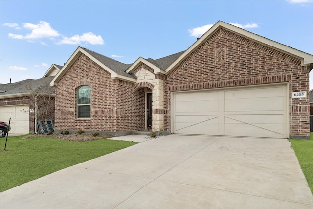 view of front of property with a garage and a front lawn