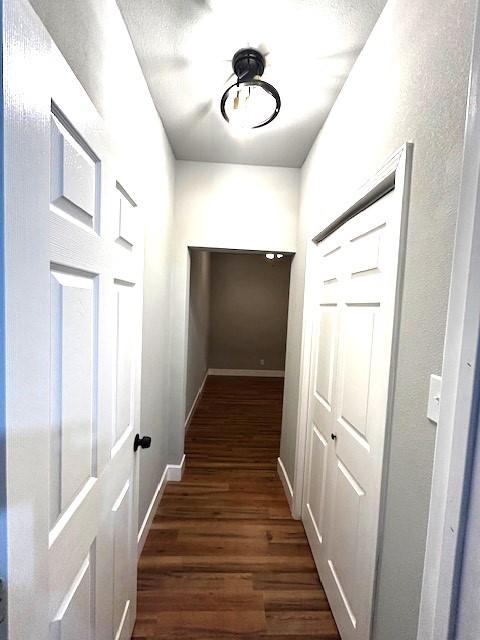 hallway with dark hardwood / wood-style floors