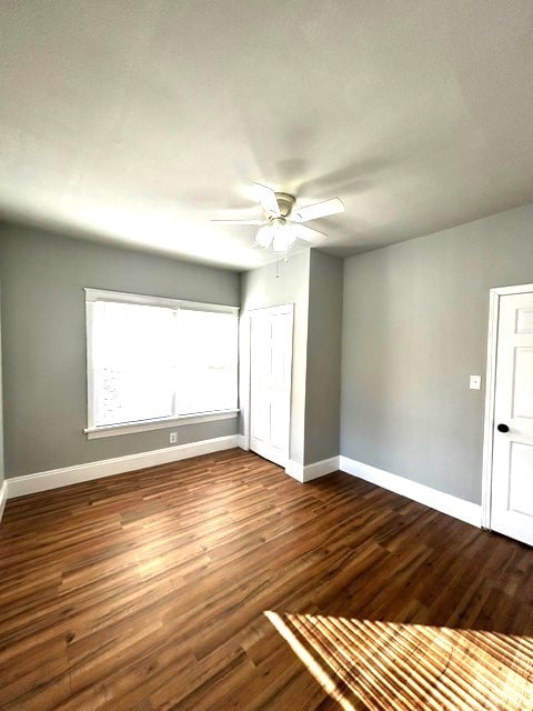 spare room with ceiling fan and dark hardwood / wood-style floors