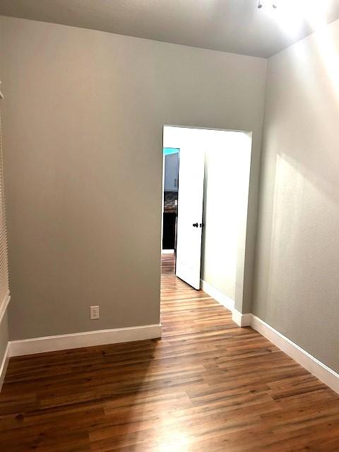 empty room with hardwood / wood-style floors