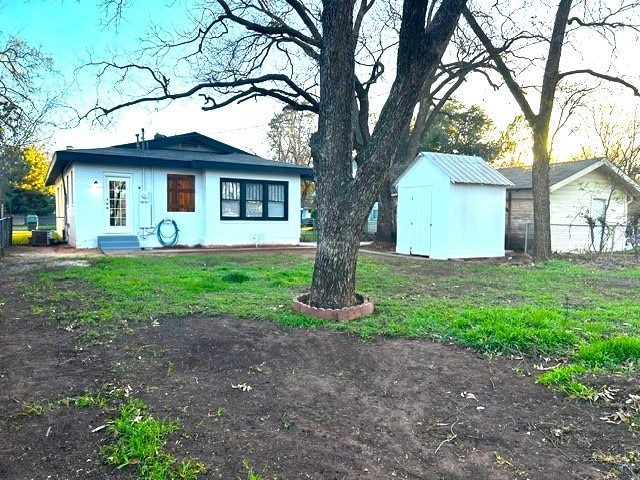 exterior space with a shed and central air condition unit